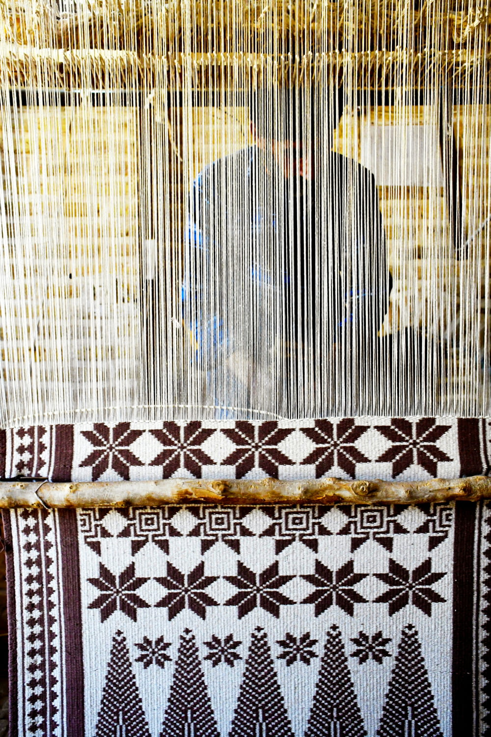 a weaving machine with a person in the background