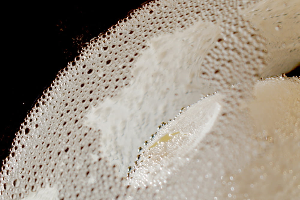 a close up of a white object with a black background