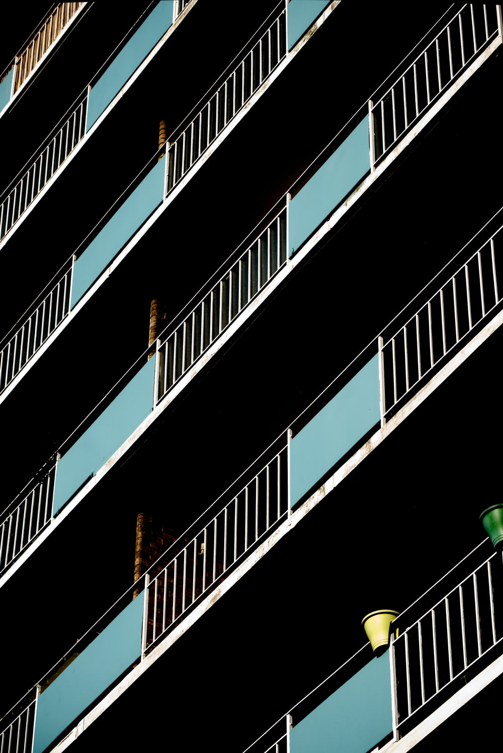 a tall building with balconies and a traffic light
