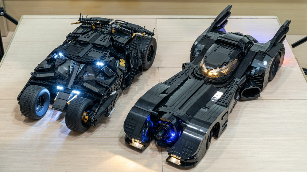 two lego batman cars are on a table