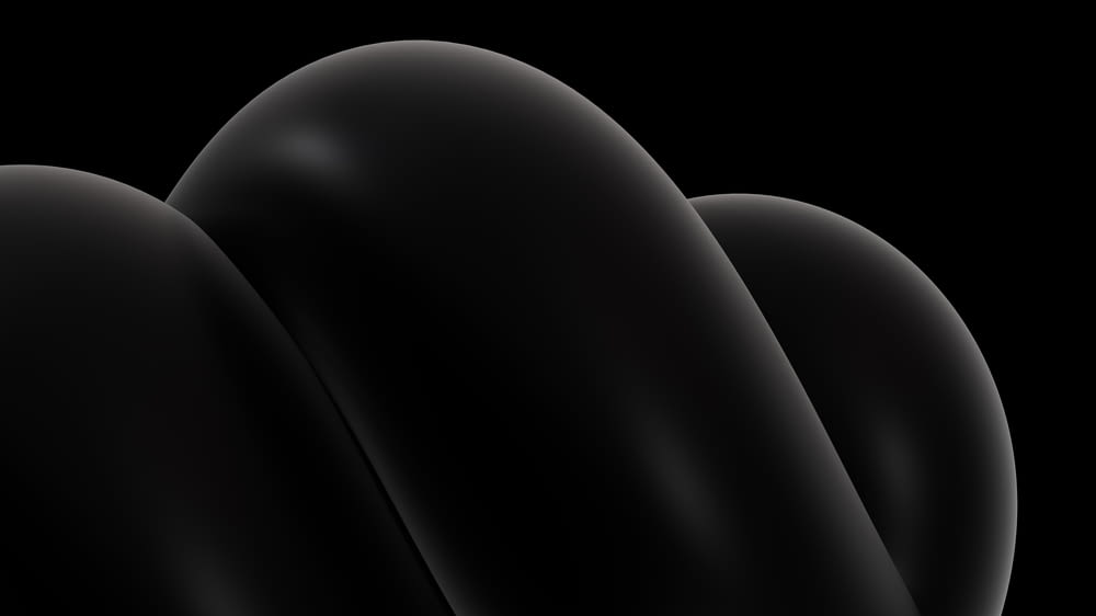 a black background with three curved objects