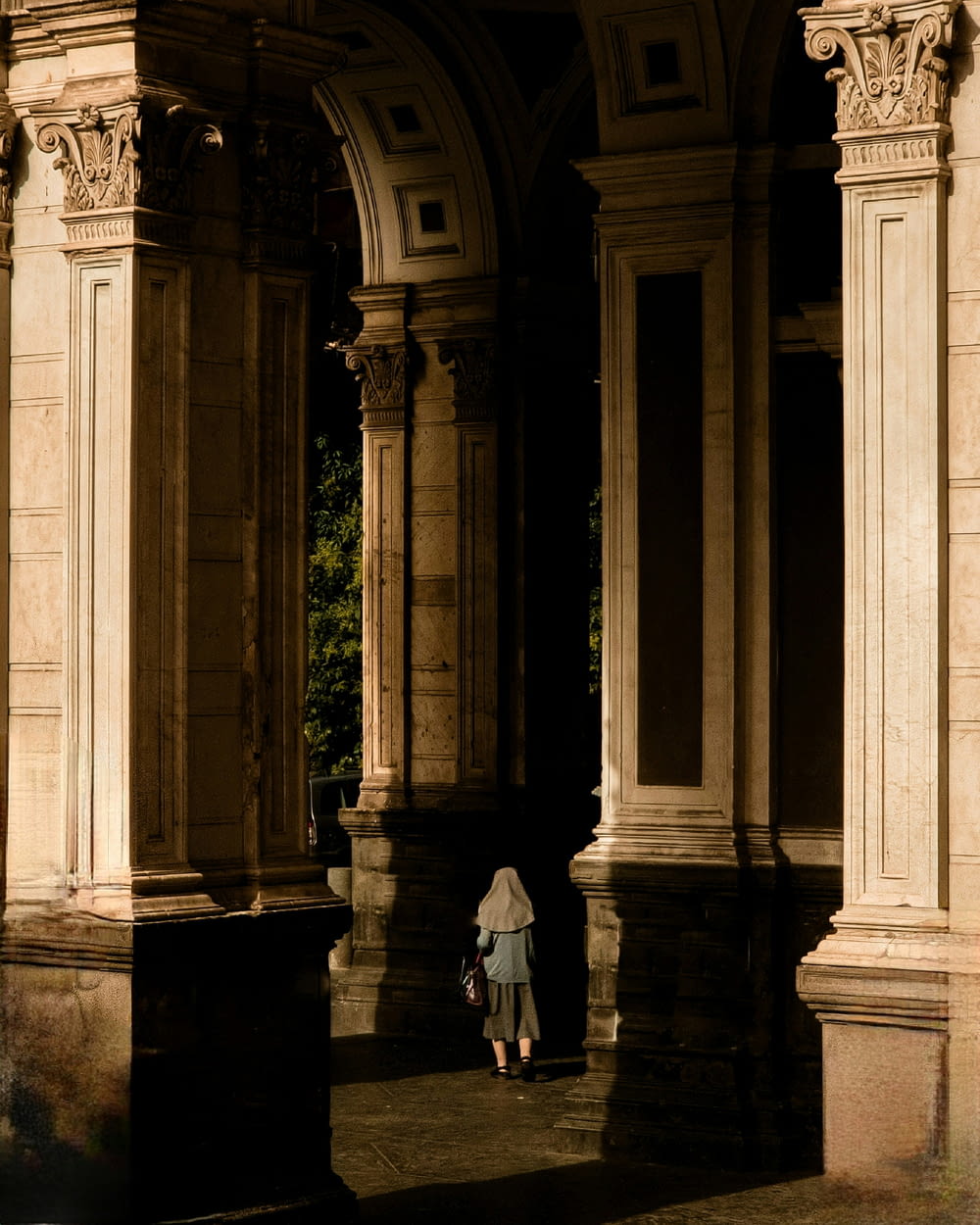 a person standing under an arch in a building
