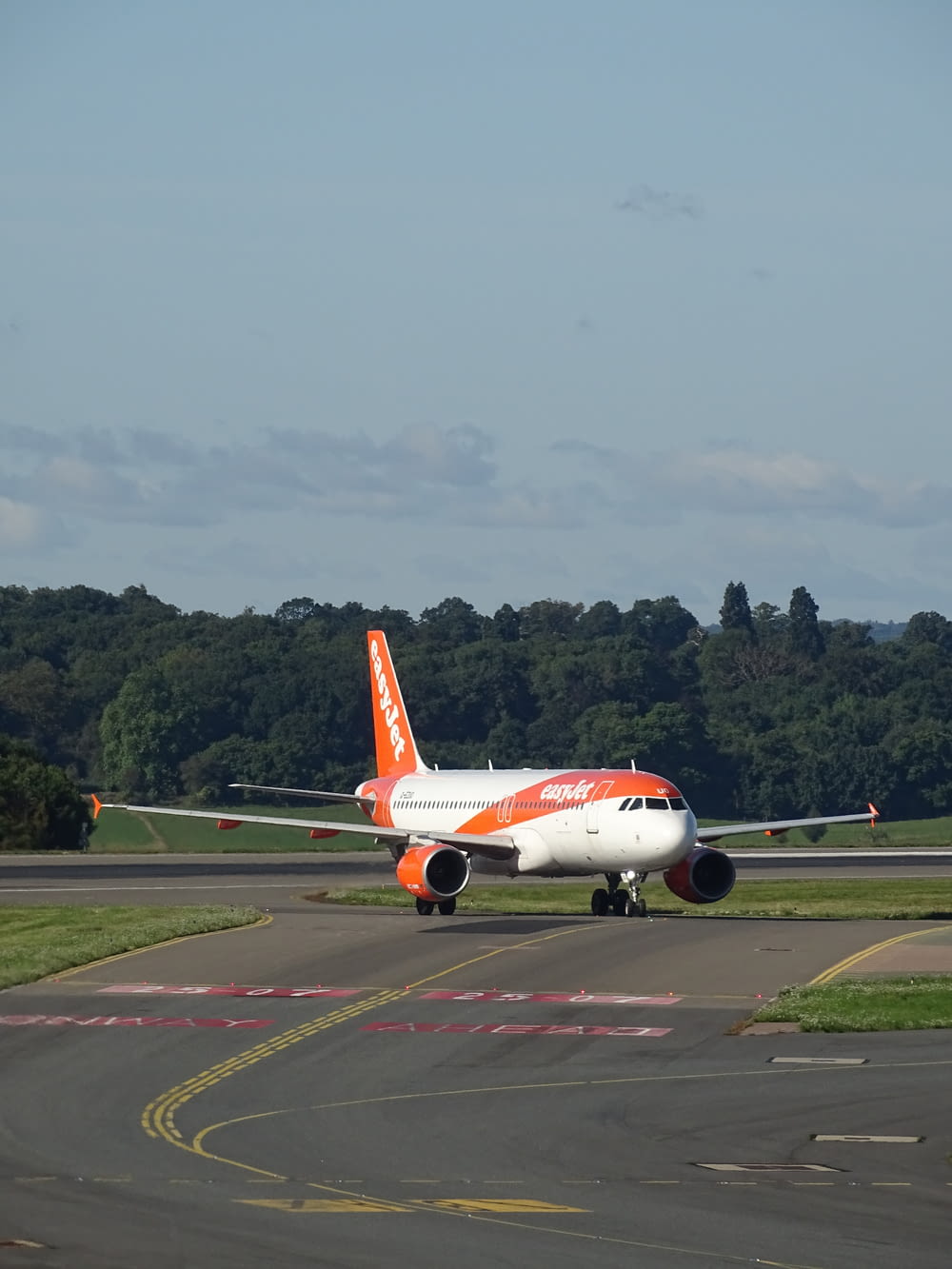 an orange and white airplane is on the runway