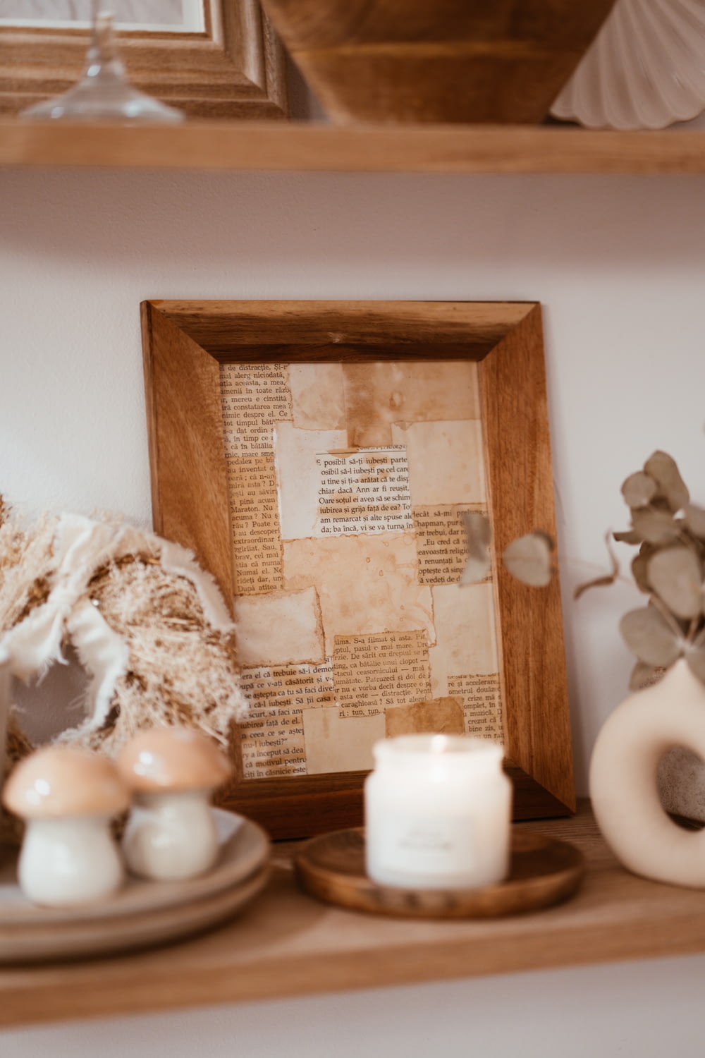 a shelf with candles and a picture frame