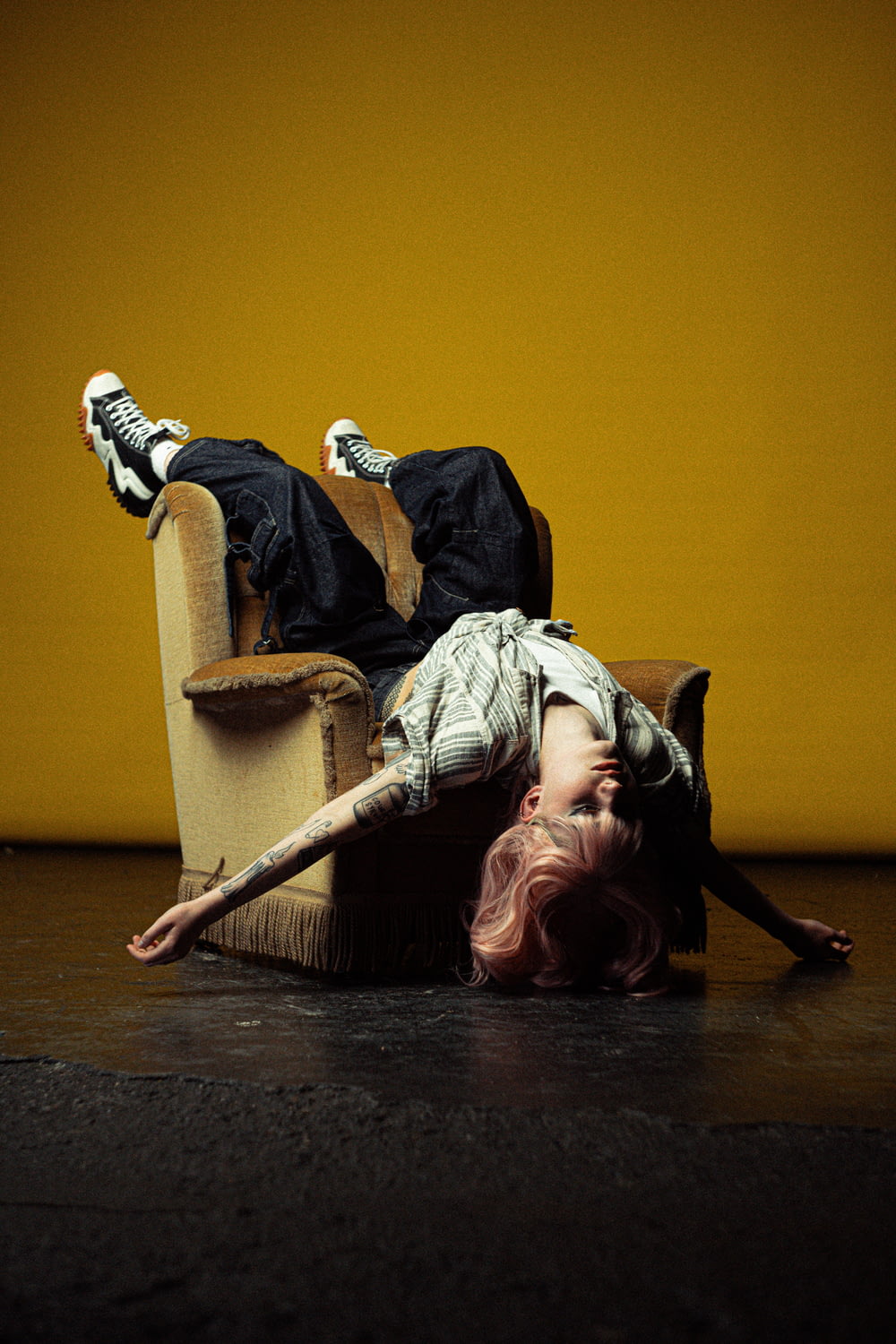 a woman laying on the floor in a chair