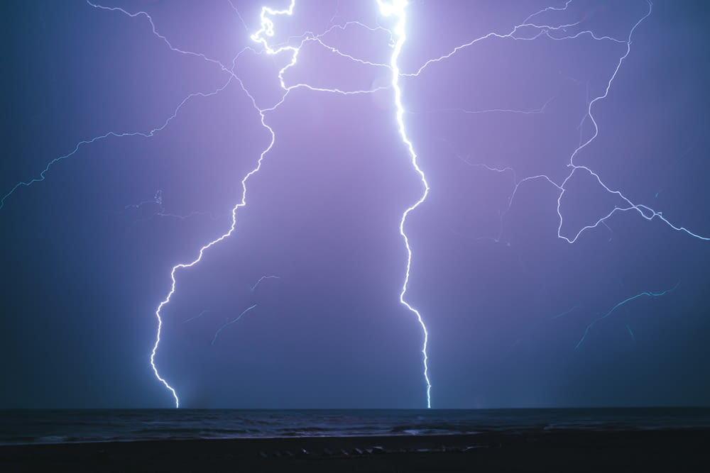 a couple of lightning strikes over the ocean