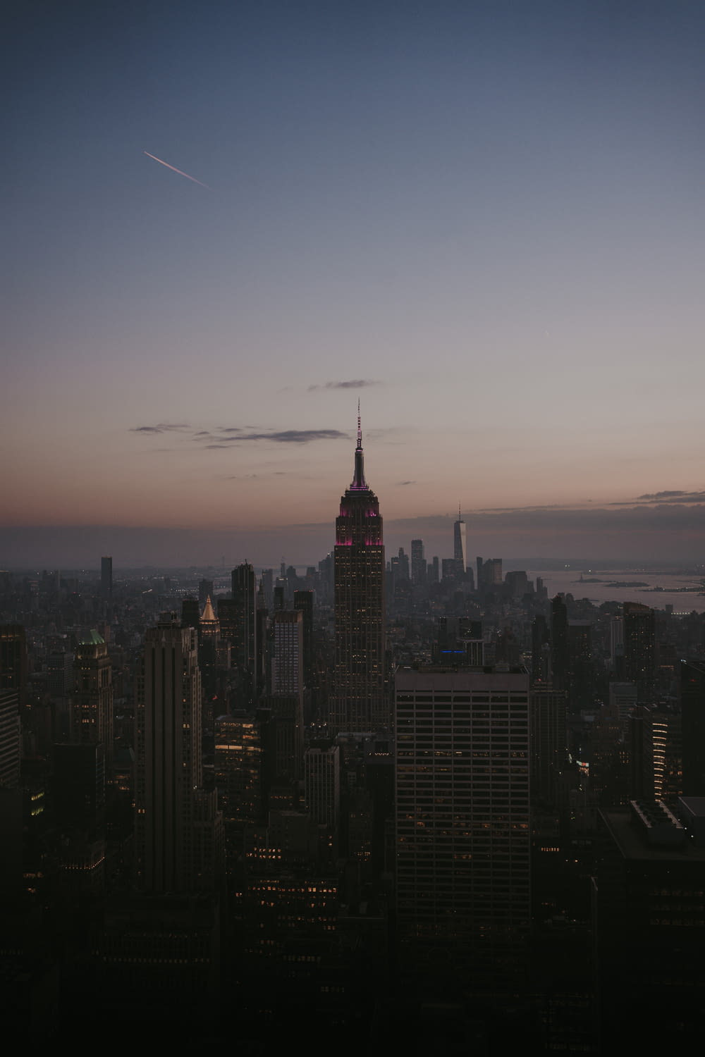 a view of a city at dusk from the top of a building