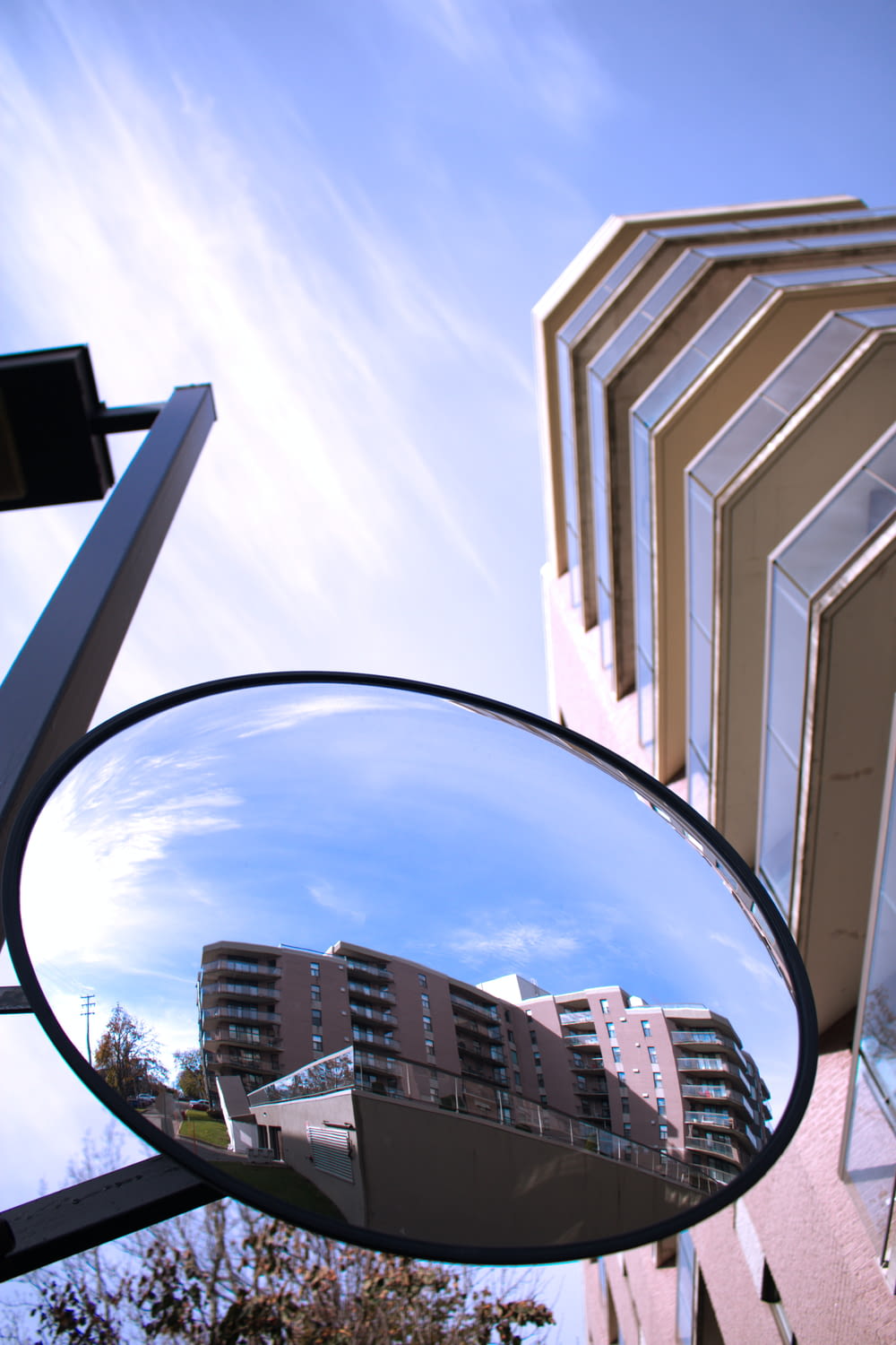 a rear view mirror on a building with a building in the background