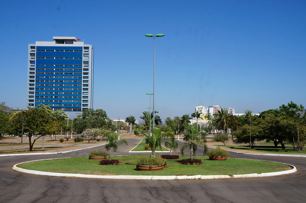 a large blue building sitting next to a lush green park