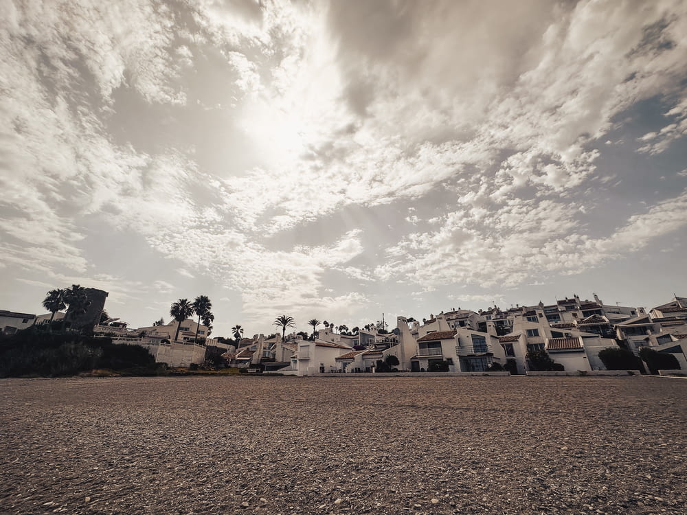 a view of a beach with houses in the background