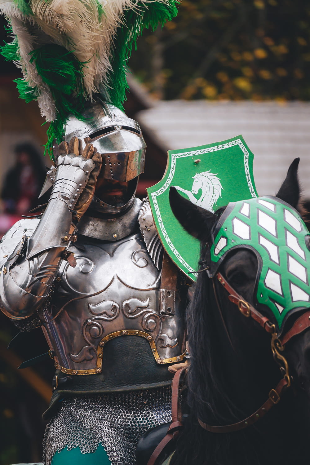 a man in a green and white costume on a horse
