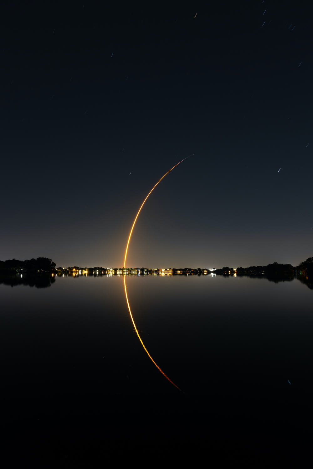 a long exposure photo of a rocket taking off