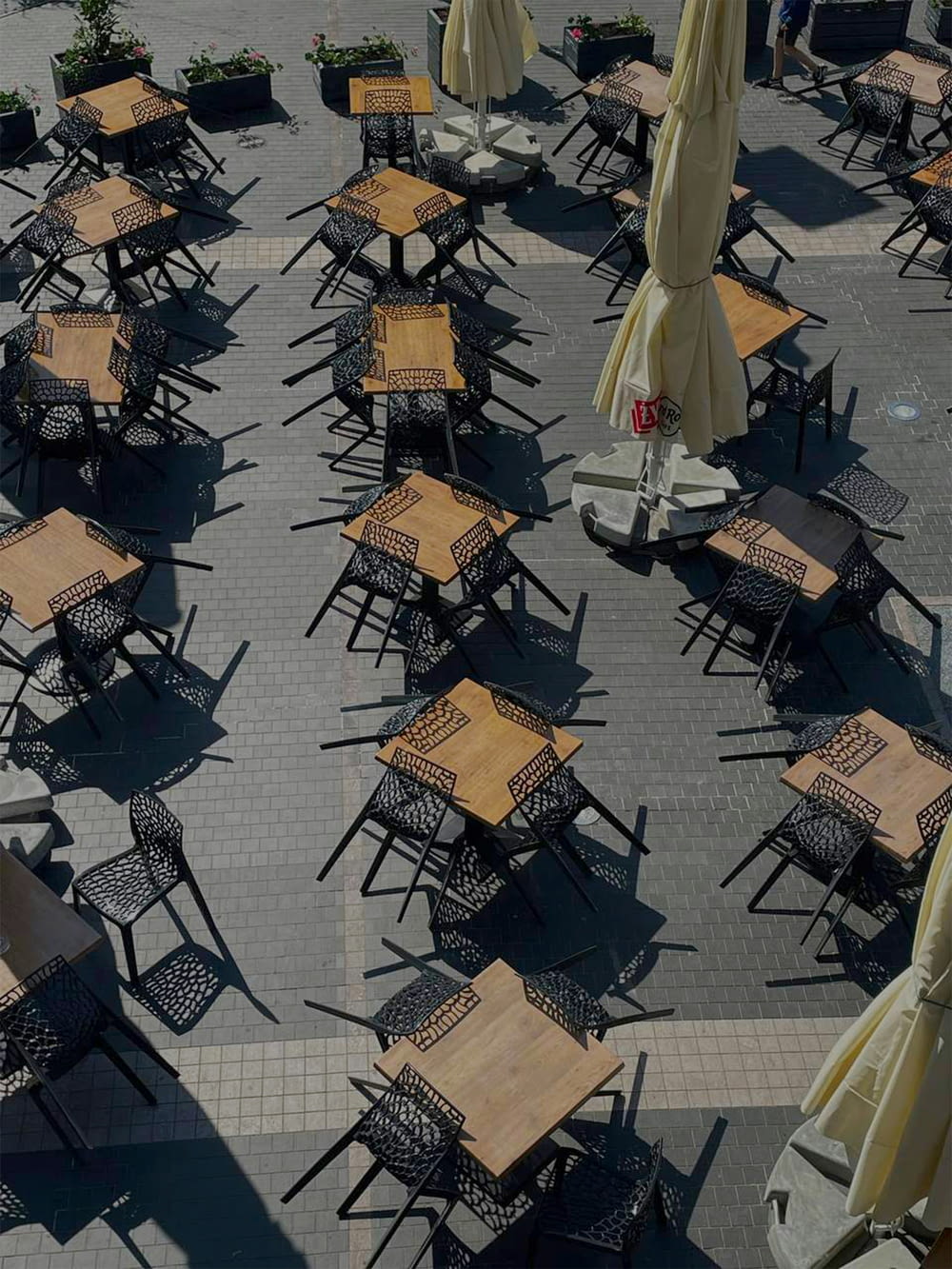 a bunch of tables and chairs with umbrellas
