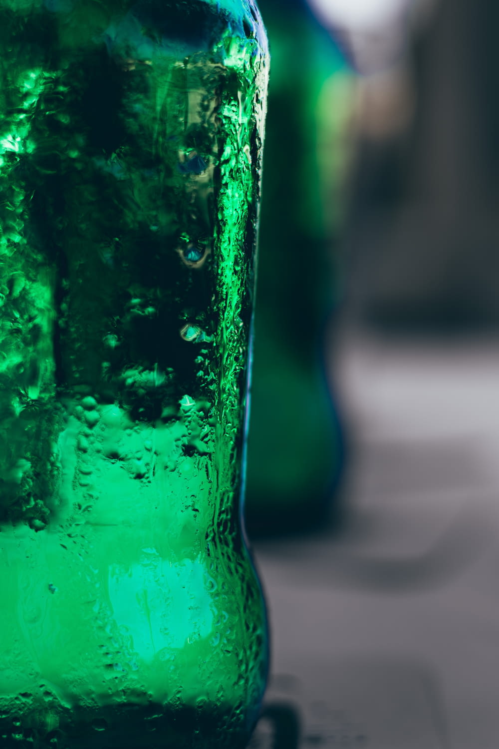 a close up of a green soda bottle