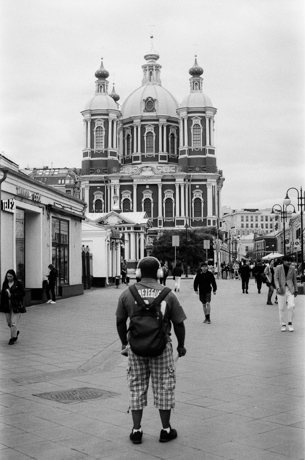 a black and white photo of a man with a backpack