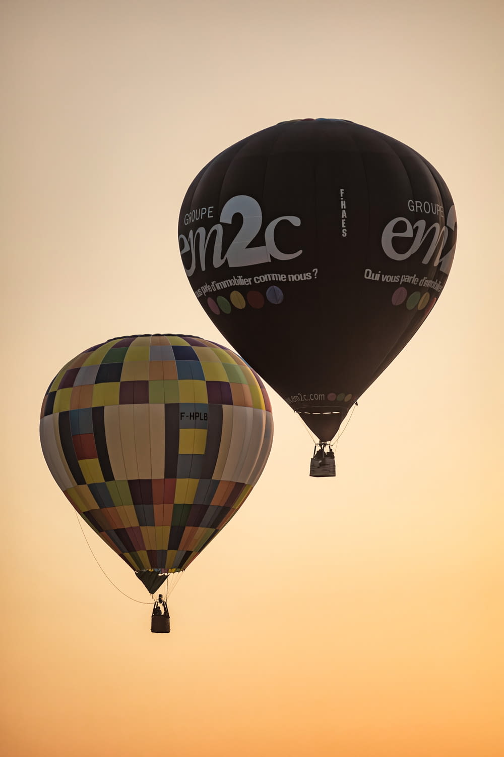 a couple of hot air balloons flying in the sky