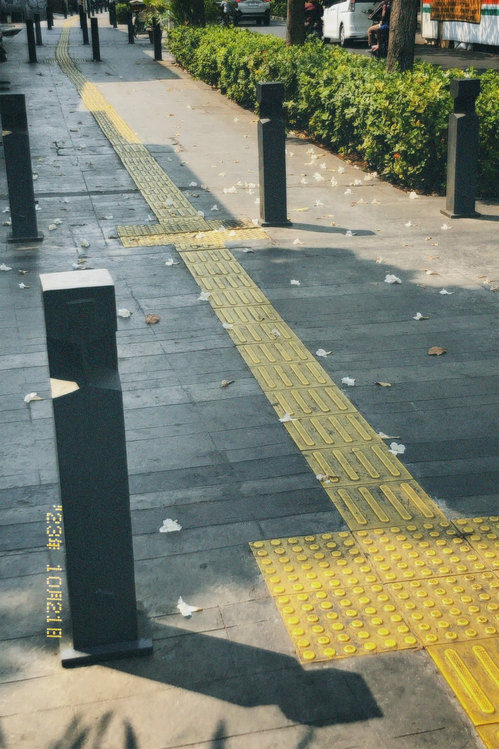 a sidewalk that has been painted yellow with a yellow line on it