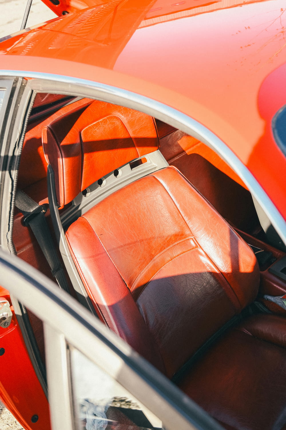 a red car with a brown leather seat