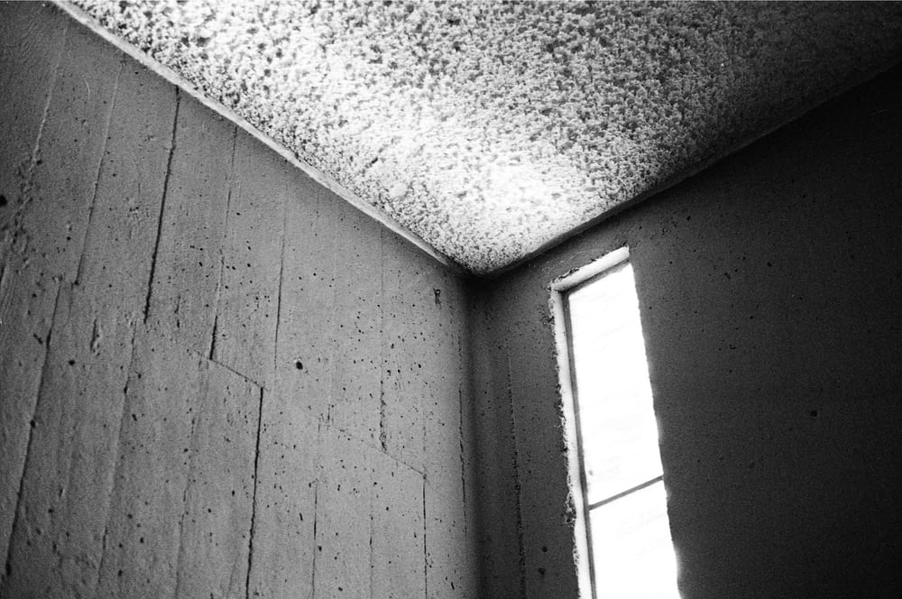 a black and white photo of a corner of a room