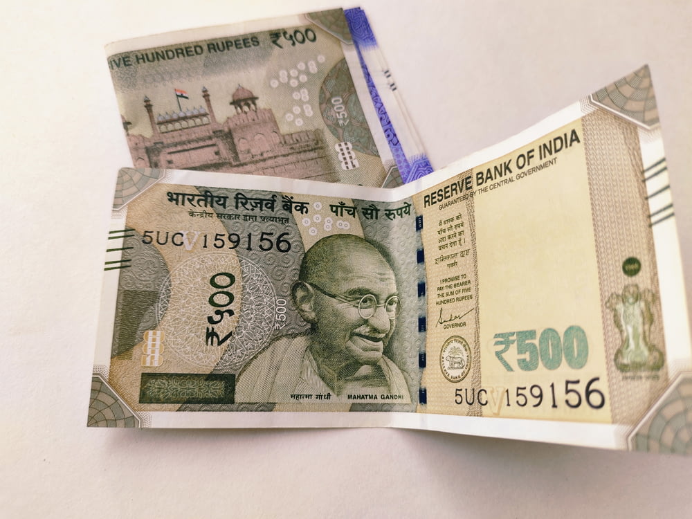 a folded indian currency bill with a picture of a man on it