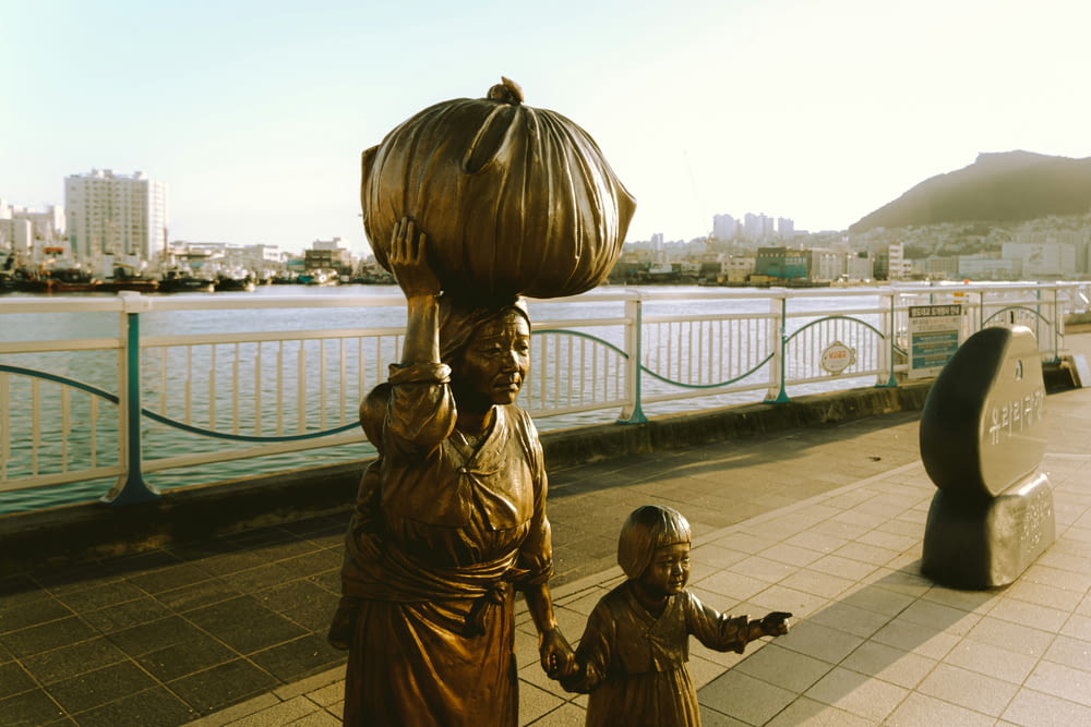 a statue of a woman carrying a basket on her head