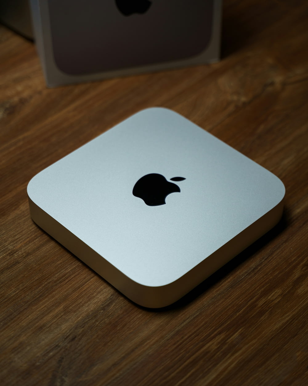 an apple computer sitting on top of a wooden table