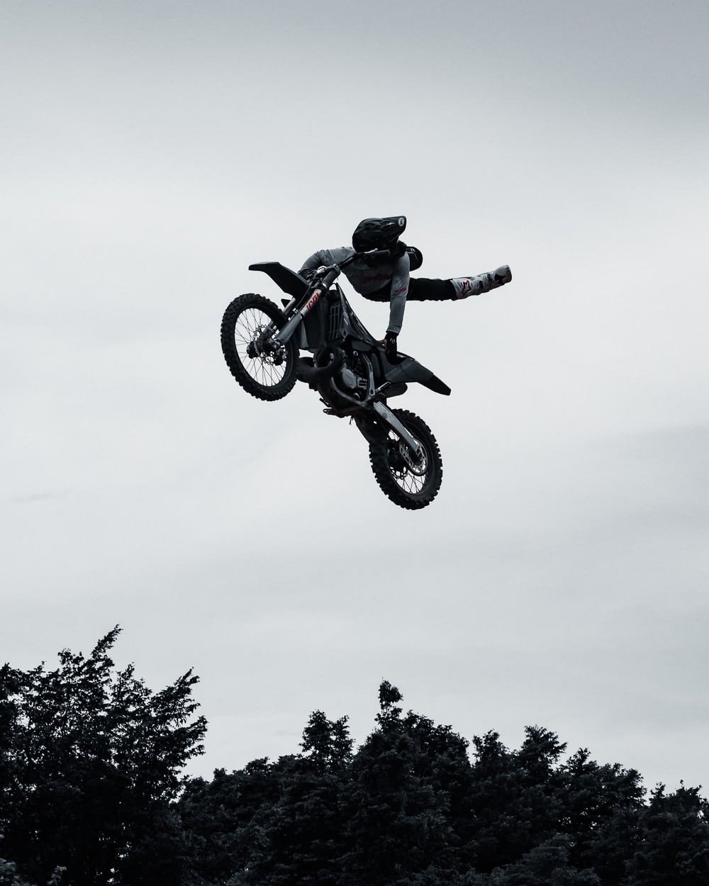 a man flying through the air while riding a motorcycle