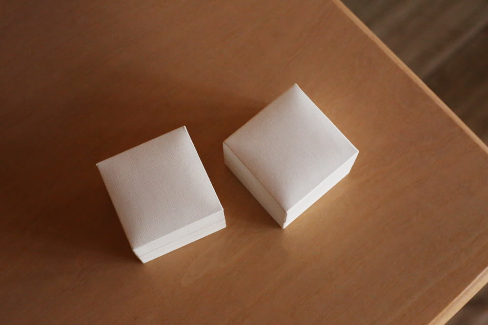 two pieces of paper sitting on top of a wooden table