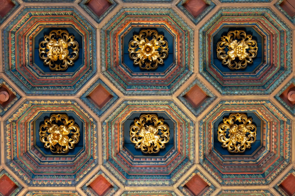 the ceiling of a building with ornate designs on it