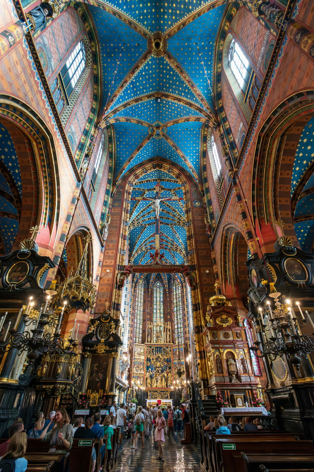 a large cathedral with a blue ceiling and many windows