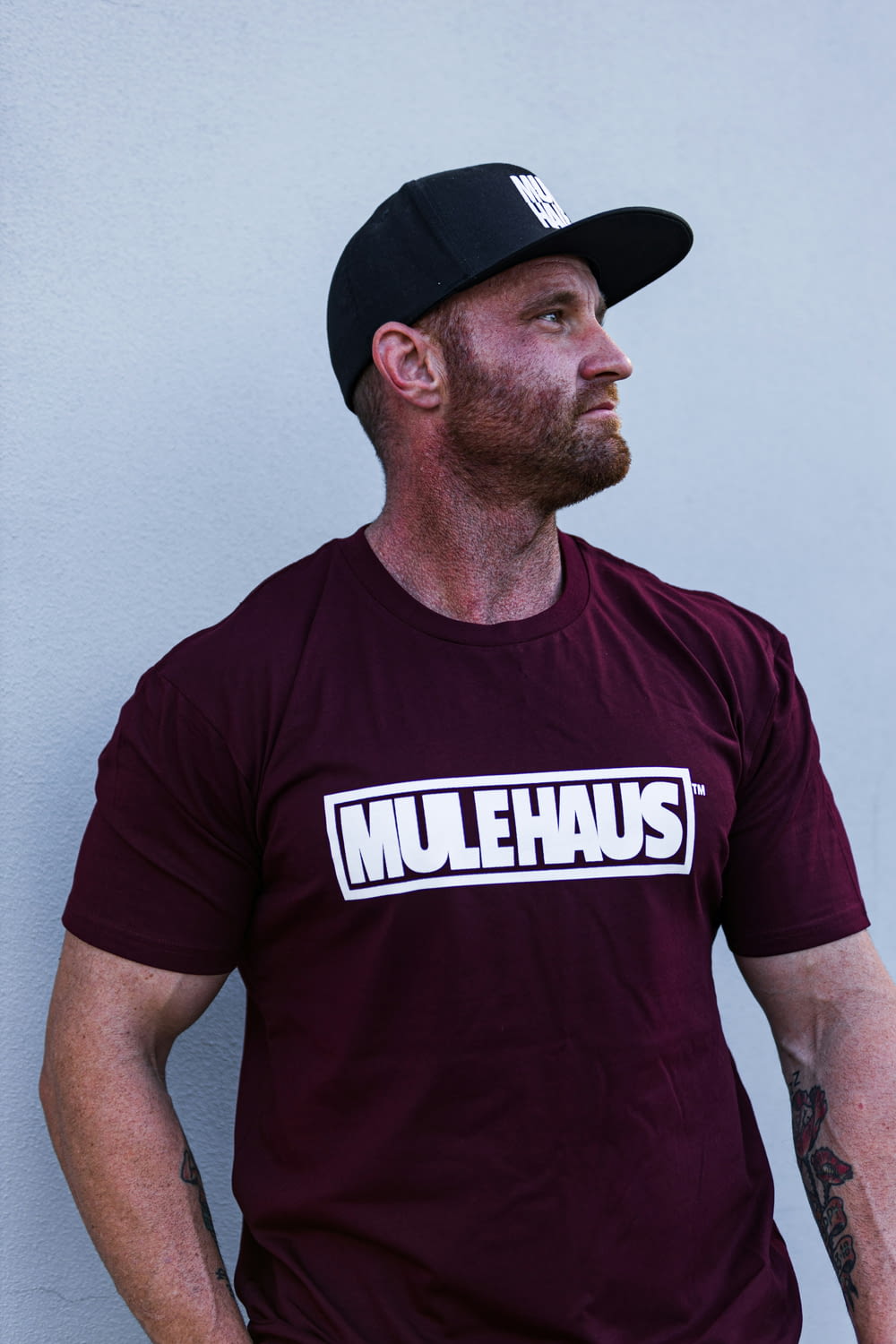 a man with a beard wearing a t - shirt that says mullehauss