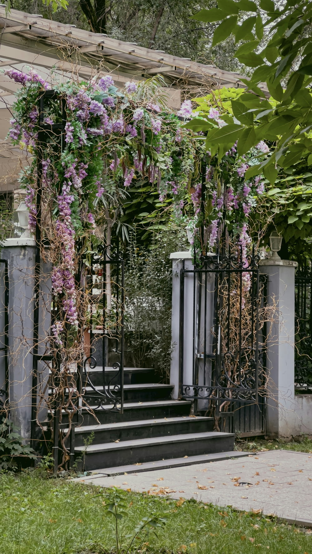 a set of stairs covered in vines and flowers