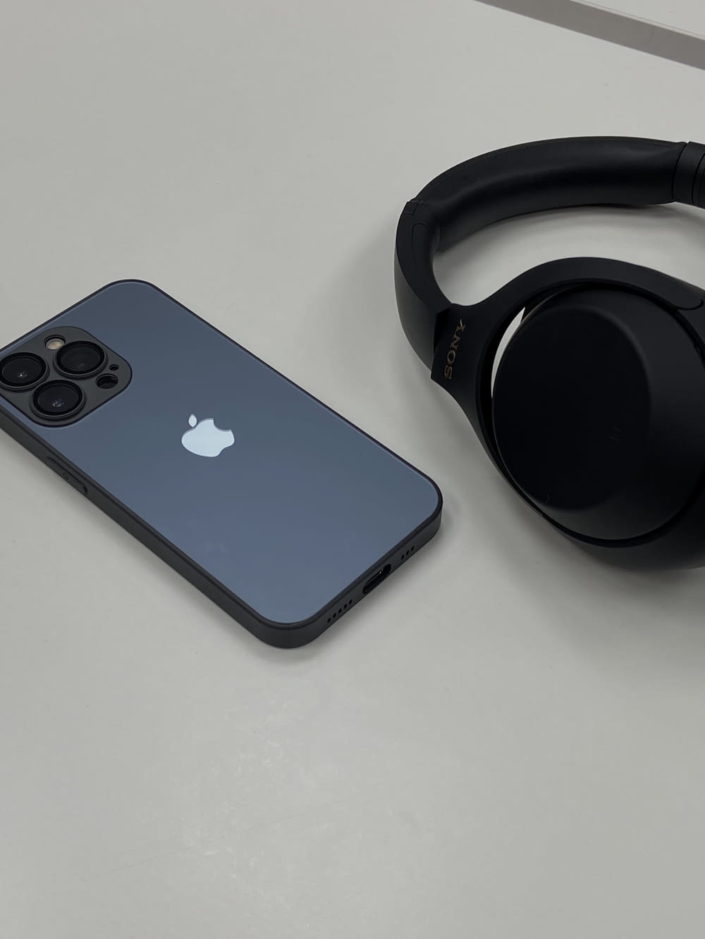a pair of headphones sitting next to an iphone
