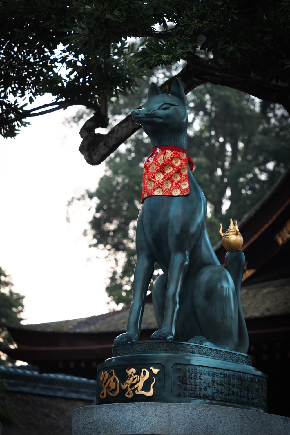 a statue of a dog with a red bandanna around its neck