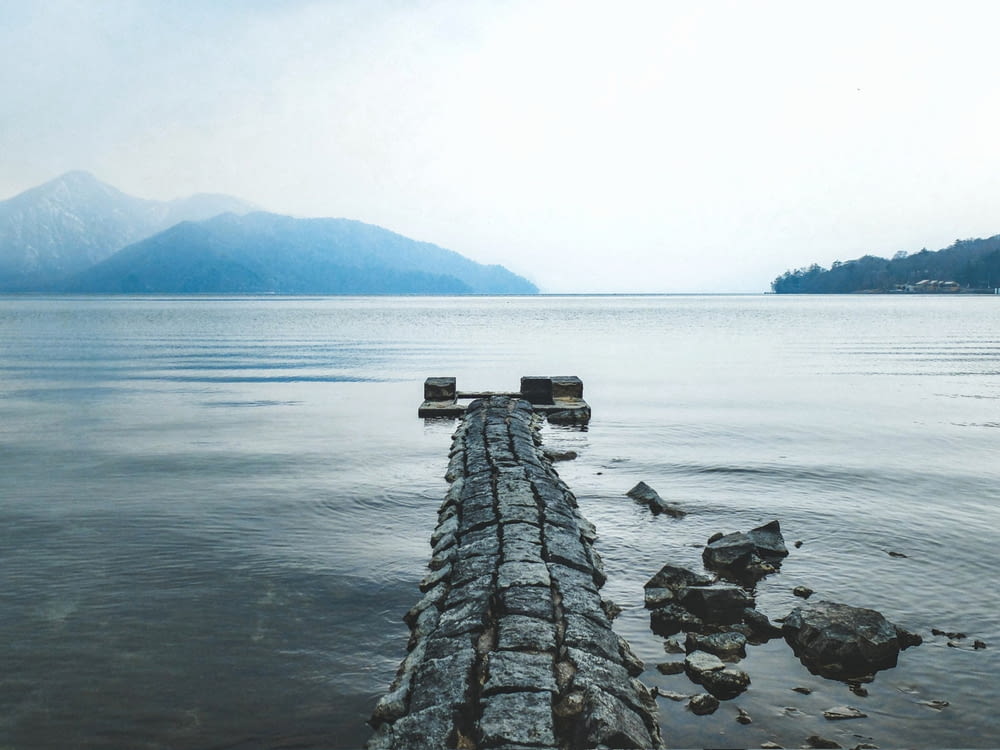 a wooden dock sitting in the middle of a lake