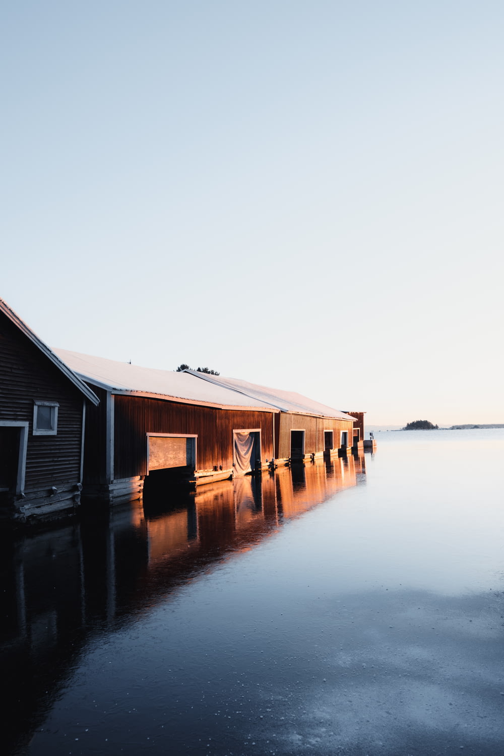 a barn sits in the middle of a body of water