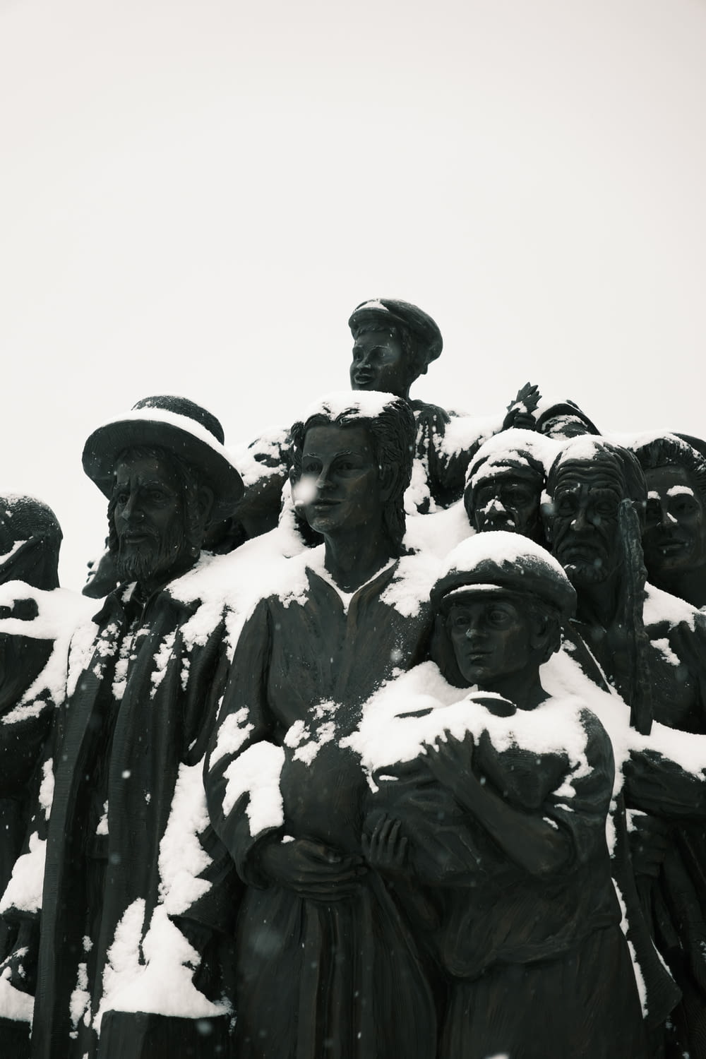 a black and white photo of a group of people covered in snow