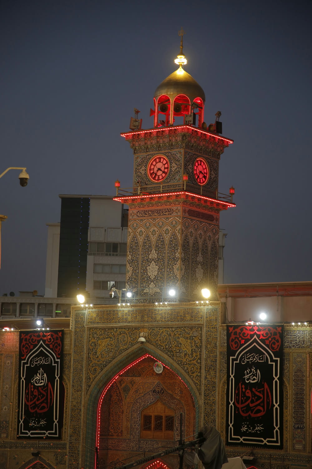 a clock tower lit up with red lights