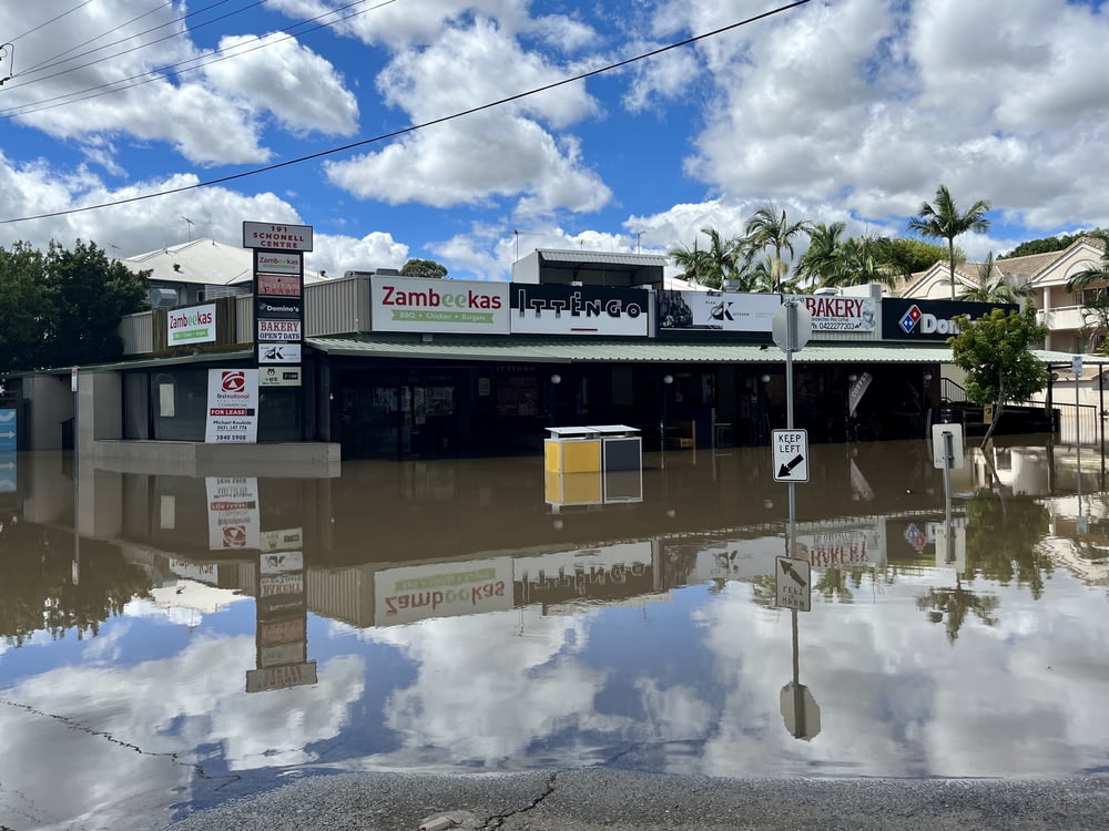 a flooded street in front of a store