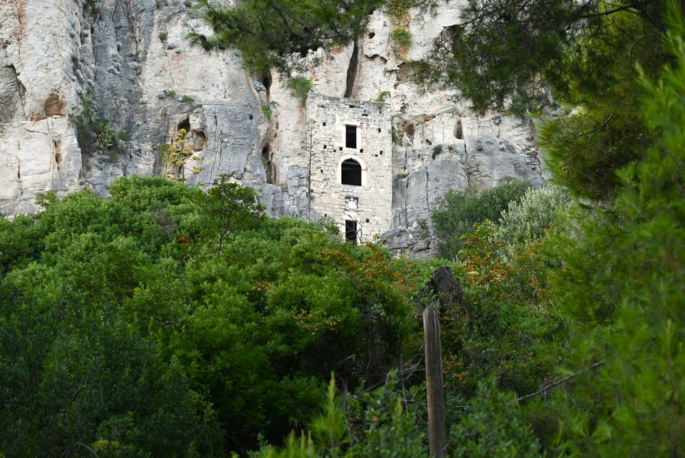 a rock face with a small window in the middle of it
