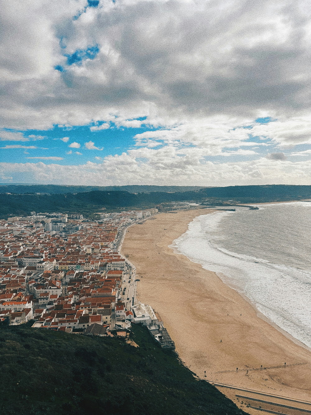 a bird's eye view of a beach and a city