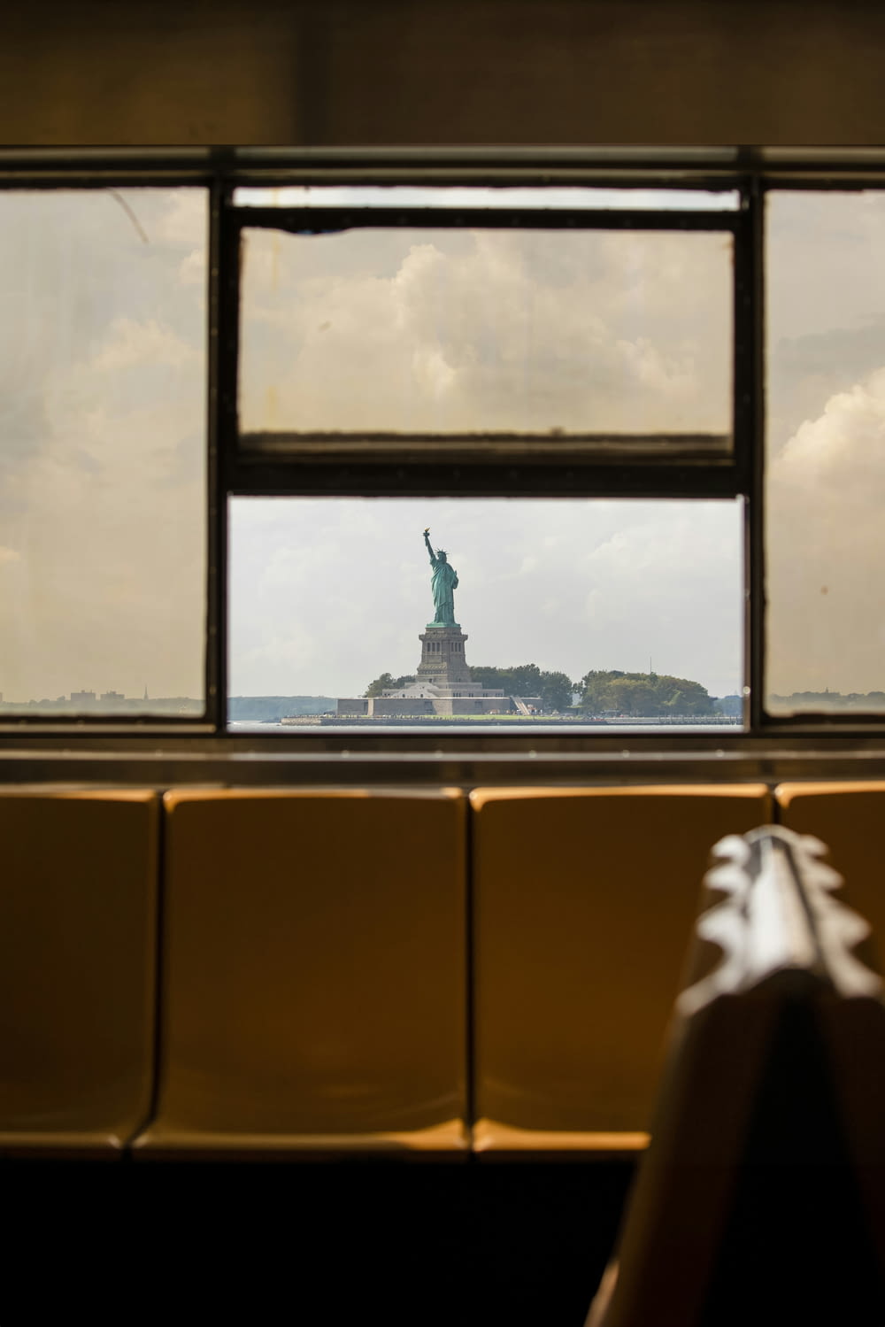 a view of the statue of liberty through a window