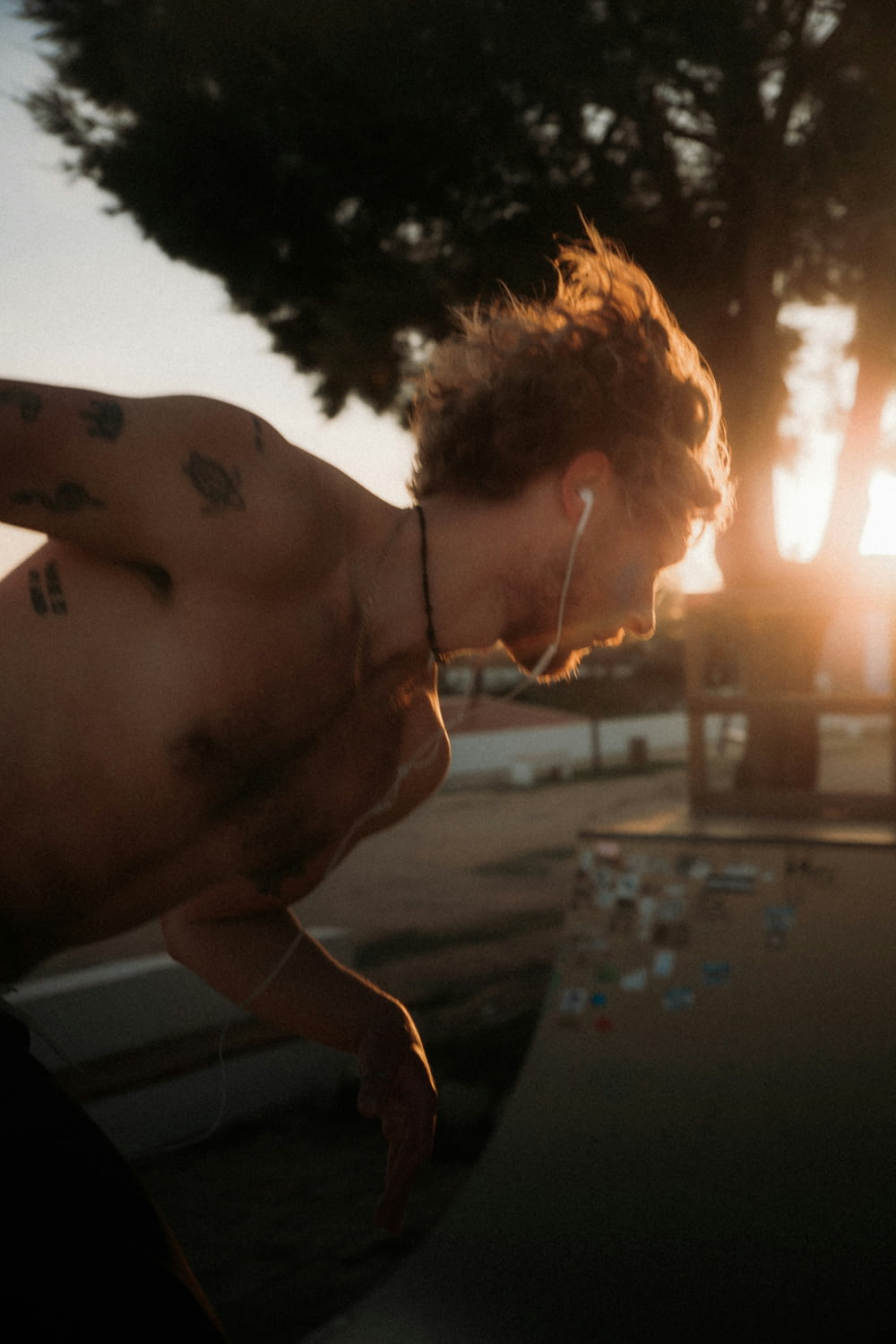 a shirtless man with no shirt on riding a skateboard