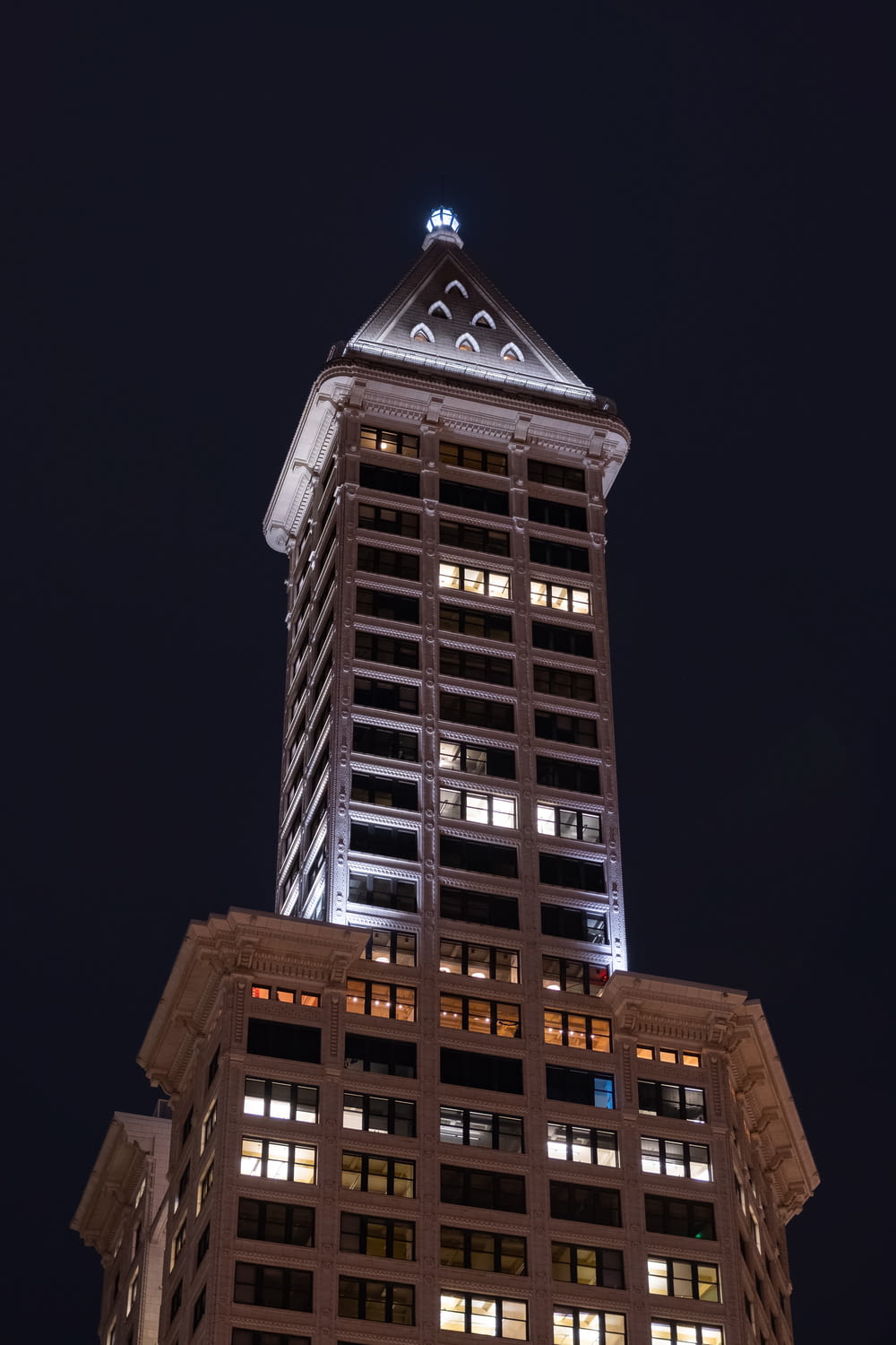 a tall building lit up at night time