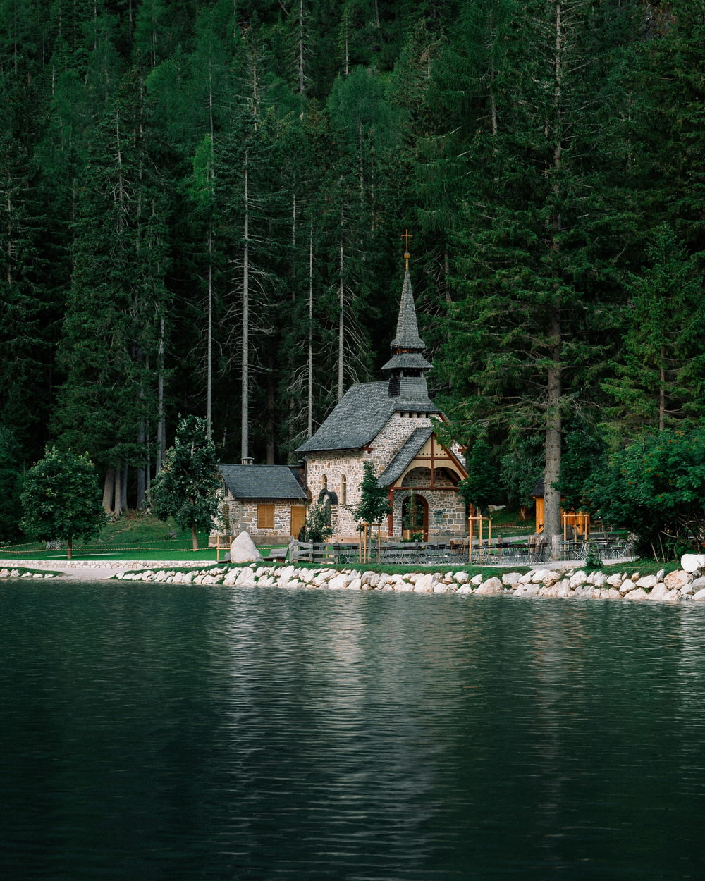 a small church on the shore of a lake