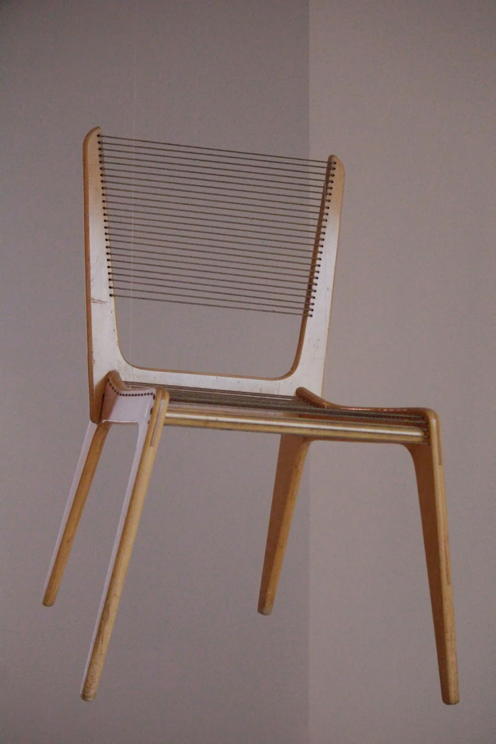 a wooden chair hanging from the ceiling