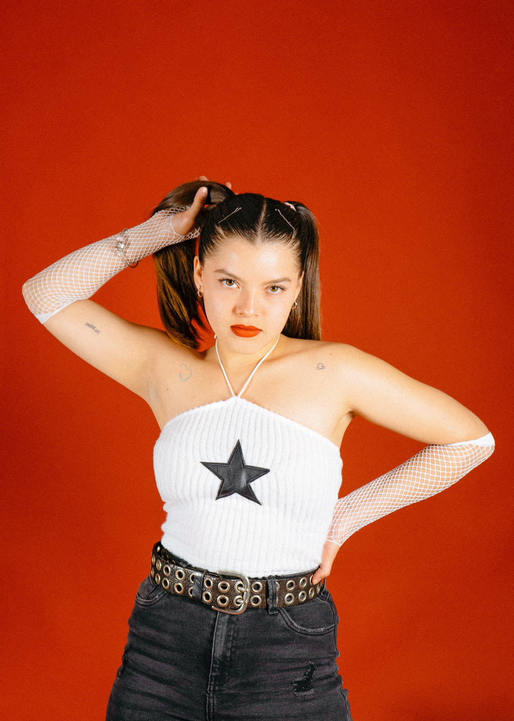 a woman in a white top with a star on her chest