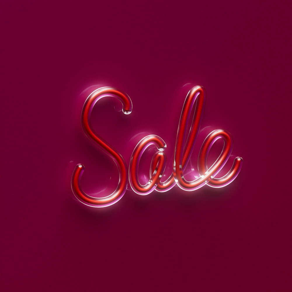 a pink background with the word sale written in neon lights