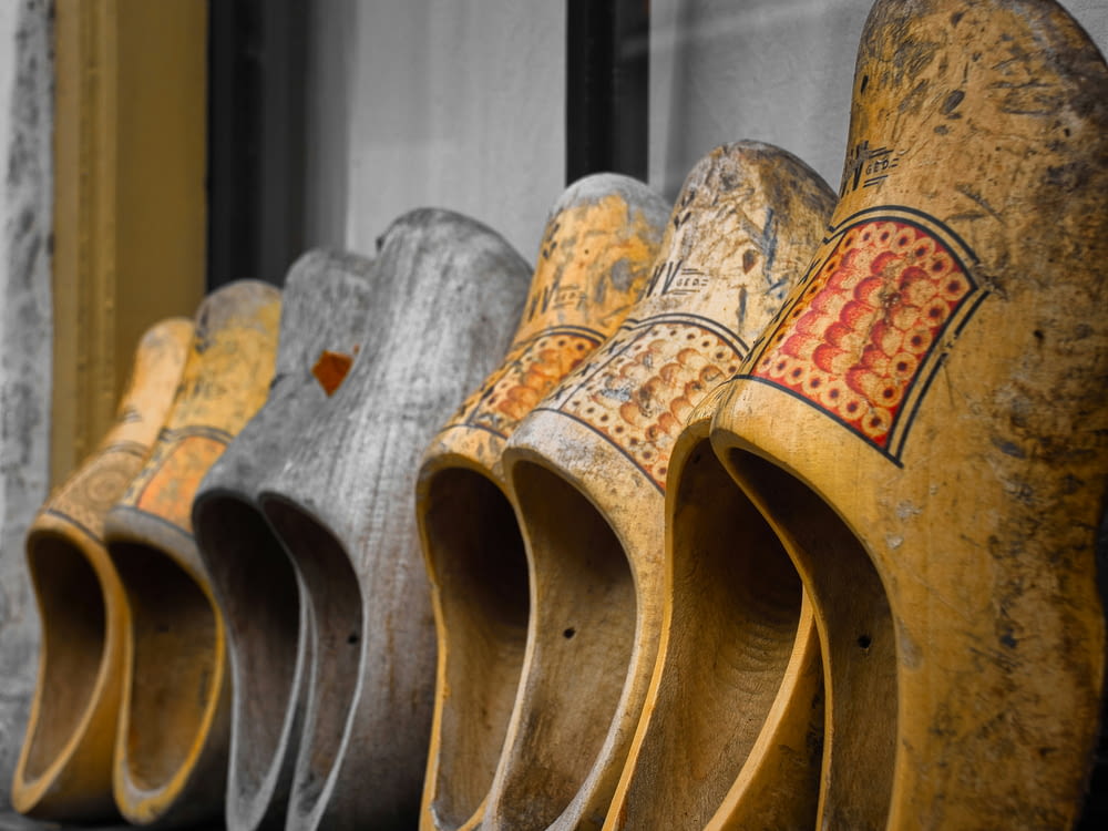 a row of wooden shoes sitting on top of a window sill