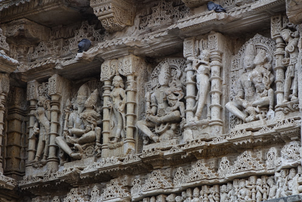 carvings on the side of a building in india